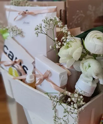 Gift box with flowers, decorated items and beautiful packaging