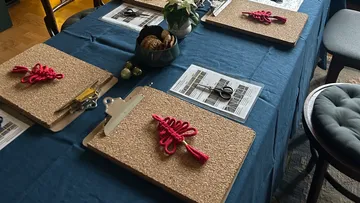 Clipboards with red string on table.