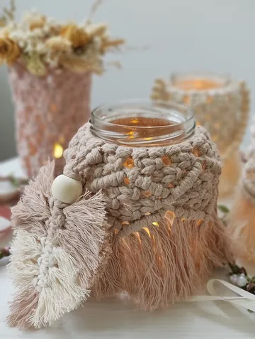 A decorative glass lantern surrounded by floral arrangements.