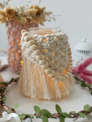Decorated glass with light surrounded by plants