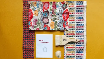 Colourful materials, instructions, brushes and konnyaku ingredients arranged.