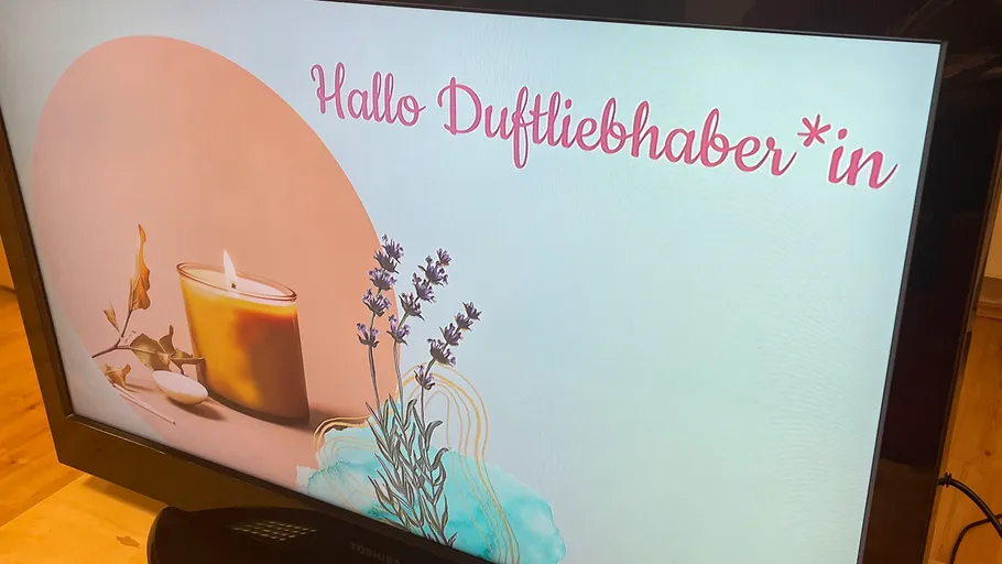 TV screen displaying candle image with text.