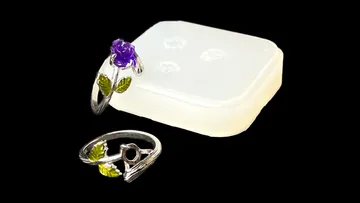 Two rings lie next to a clear storage box.