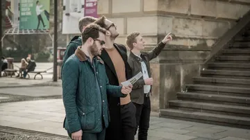 A group of men are looking at an outdoor attraction.