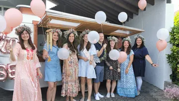 Group of people with balloons in a festive setting.