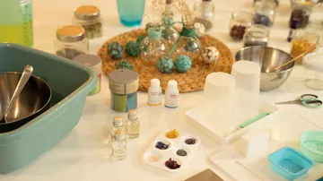 Kitchen utensils and glass containers for mixing colors and ingredients.