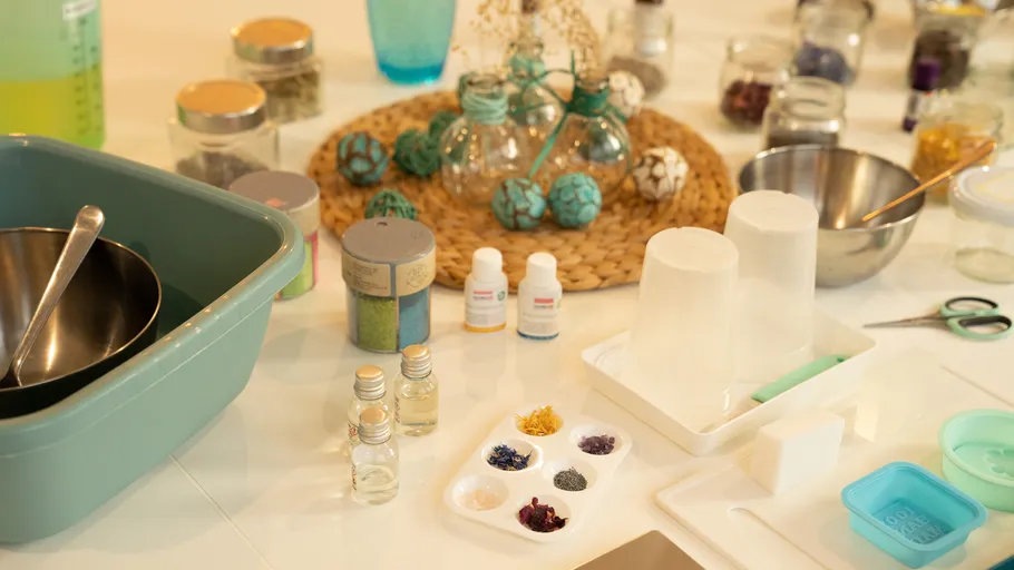 Kitchen utensils and glass containers for mixing colors and ingredients.
