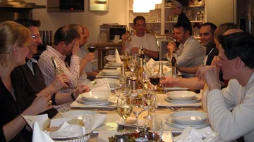 A group of people sit at a set table.