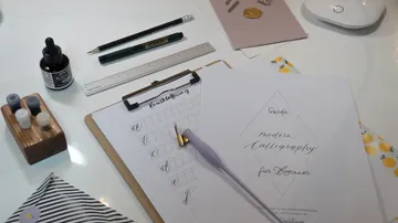 Calligraphy tools are on a table for practice.
