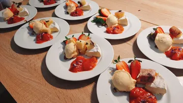 Plate arranged with dessert, ice cream and fresh fruit.