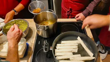 Cooking utensils prepare fried food in a kitchen.