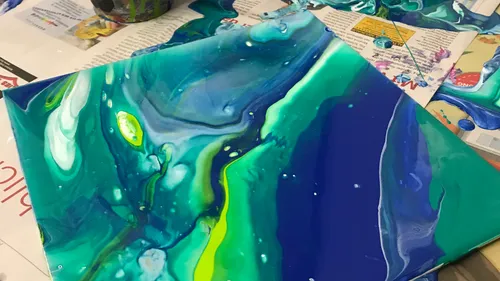 Colourful colours mix on a painted canvas.