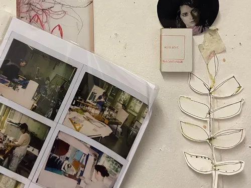 Pictures on a wall show people doing creative work.