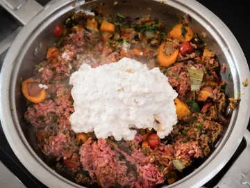 Eine Pfanne mit angebratenem Hackfleisch und Gemüse.