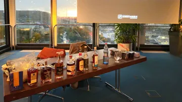 Table with spirits and drinks in a modern setting.