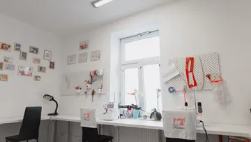 Sewing machine works in a bright, creative space.