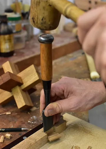 A wood chisel is machined with a hammer.
