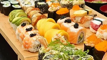Colourful sushi rolls arranged on a wooden board