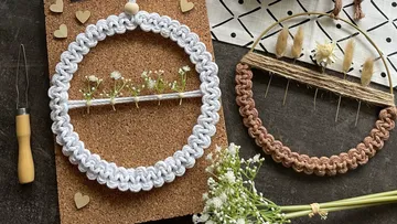 Two decorative craft frames with dried flowers on cork
