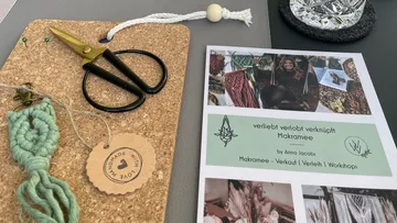 cork board with scissors, thread, instructions and decorative elements.