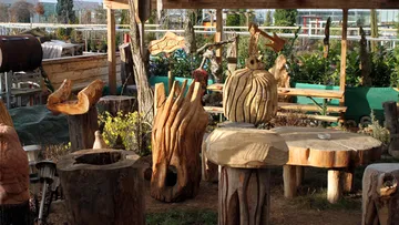 Wooden sculptures are decorative in a garden area.