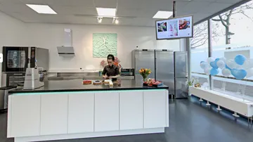 A woman is preparing food in a modern kitchen.