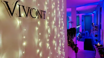 Glowing lights line an inviting, colorful interior view.