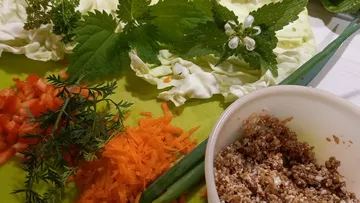 Ingredients are prepared on a cutting board to cook.