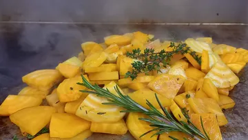 Sliced pumpkin pieces are stewed with herbs.