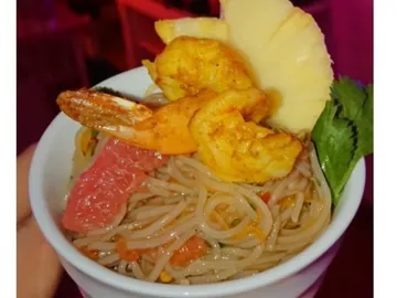 Bowl of pasta, shrimp, pineapple and vegetables.