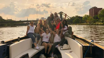 Gruppierung von Frauen feiert fröhlich auf einem Boot.