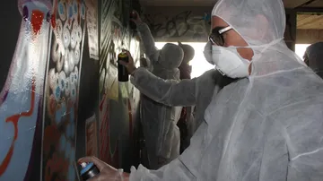 Spray cans are used to paint walls.