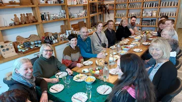 Group conference at the table with food and drinks in the background.