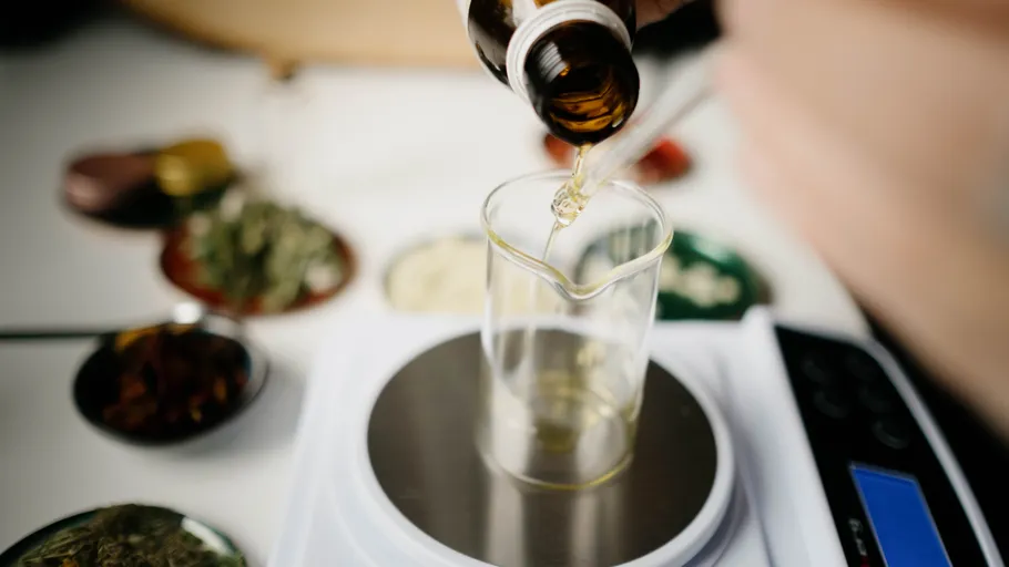 Pouring liquid into beaker on scale