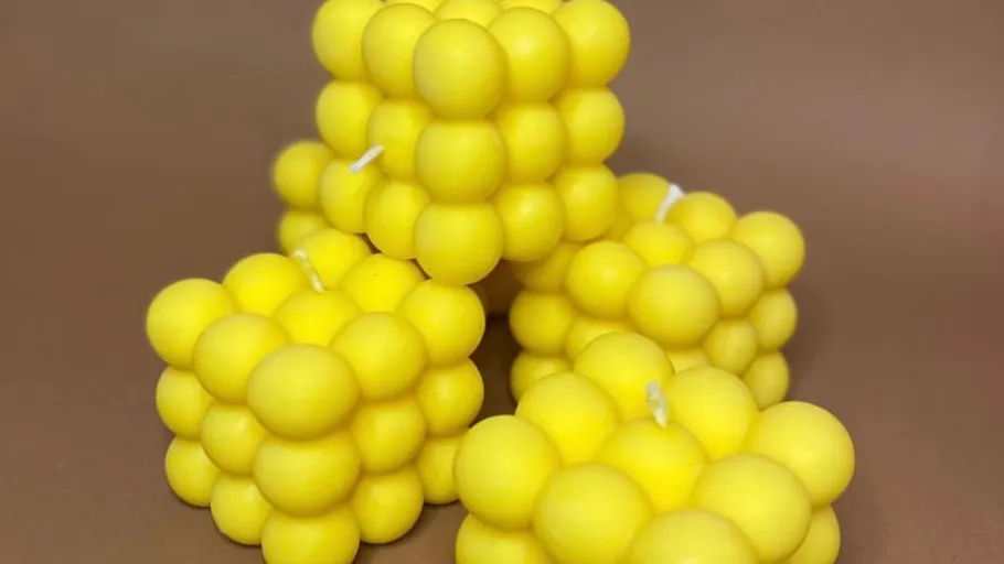 Yellow bubble candles on brown background.