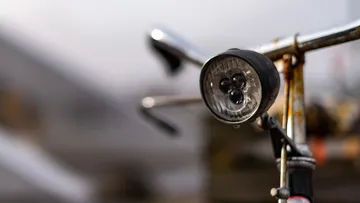 Bike lamp on the handlebars, ready for the ride.