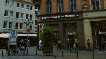 Bookshop stands on a busy street with passers-by.