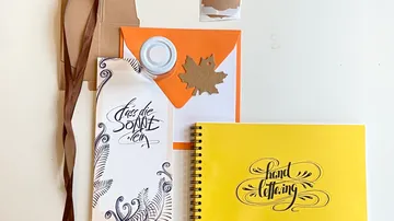 Paper materials lay flat, creative design and hand lettering.