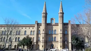 Historic building with towers, under blue skies.
