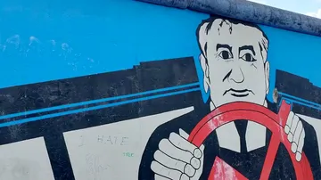 Mural shows a man holding a steering wheel.