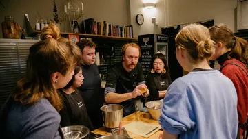 Cooking class: Participants learn from an instructor at the table.