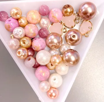 Colourful pearls lie in a white bowl.