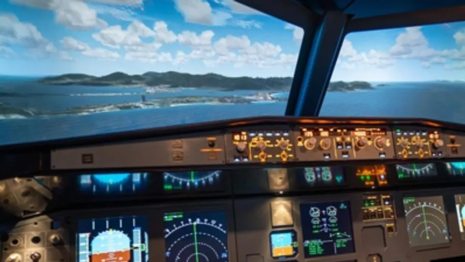 Airplane cockpit shows views of the sea and mountains.
