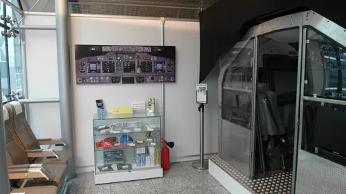 Airport location with a cockpit simulator and shop window.