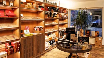 Cigarrettes and accessories are on display in a cozy shop.