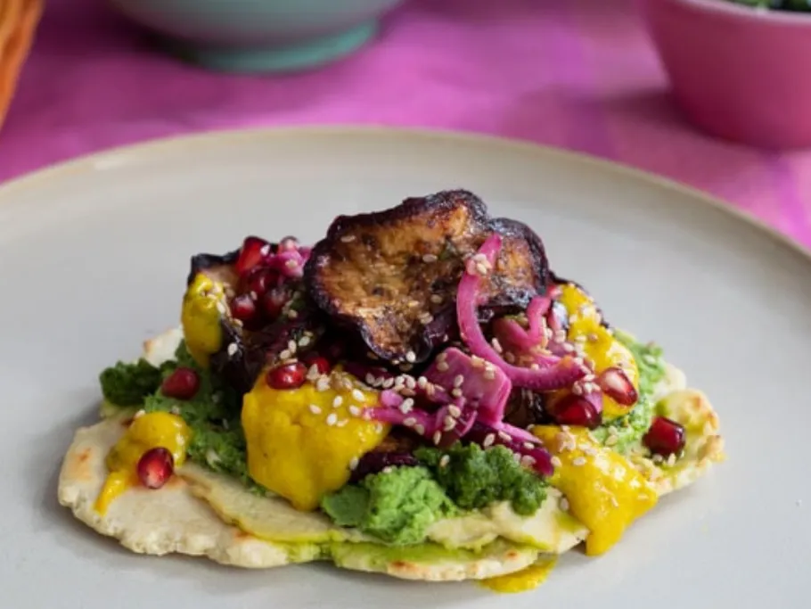 A colorful plate with various types of vegetables and sauces.