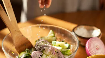 Ingredients are mixed with salt in a bowl.
