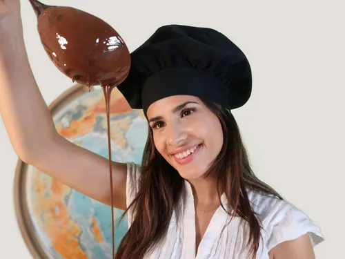 Chef holds a bowl of liquid chocolate in front of Globus.