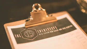 Clipboard with menu for liquor tasting in a bar.
