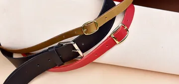 Three belts lie on top of each other on a light background.